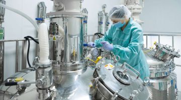 Pharmaceutical technician in sterile environment at pharmacy industry