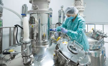 Pharmaceutical technician in sterile environment at pharmacy industry